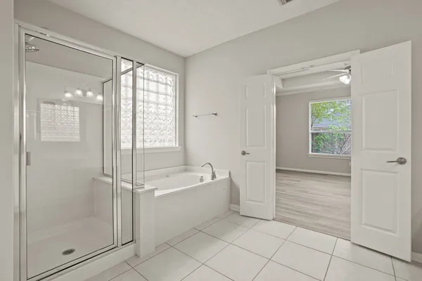 a bathroom with a bathtub and a shower