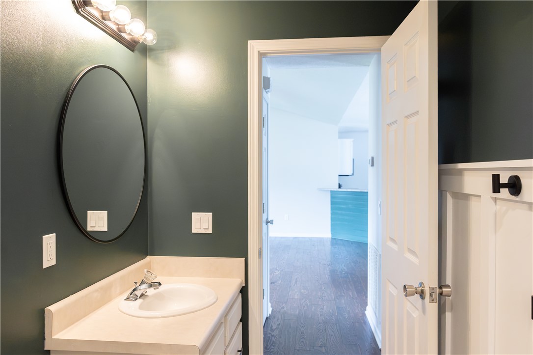 439 Chetola Road Seneca, SC 29672 - Photo 9 of 28 A classic vanity set highlights this convenient half bathroom with a view into the living areas.