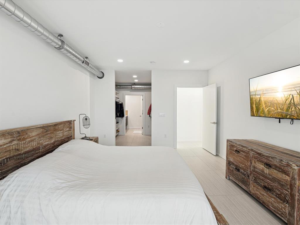 50 Coe Road, Unit 126 Belleair, FL 33756 - Photo 12 of 39 a bedroom with a bed and a flat screen tv