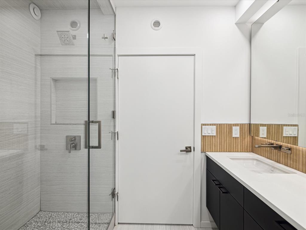 50 Coe Road, Unit 126 Belleair, FL 33756 - Photo 14 of 39 a bathroom with a shower sink and mirror