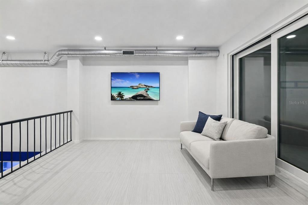 50 Coe Road, Unit 126 Belleair, FL 33756 - Photo 22 of 39 a living room with furniture and a flat screen tv