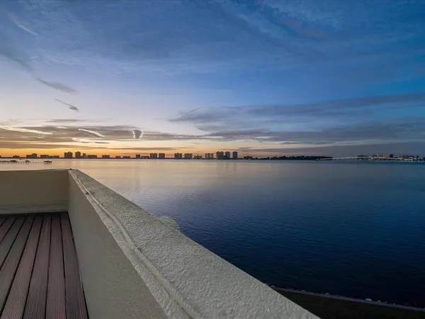 an aerial view of a house with pool lake view and mountain view