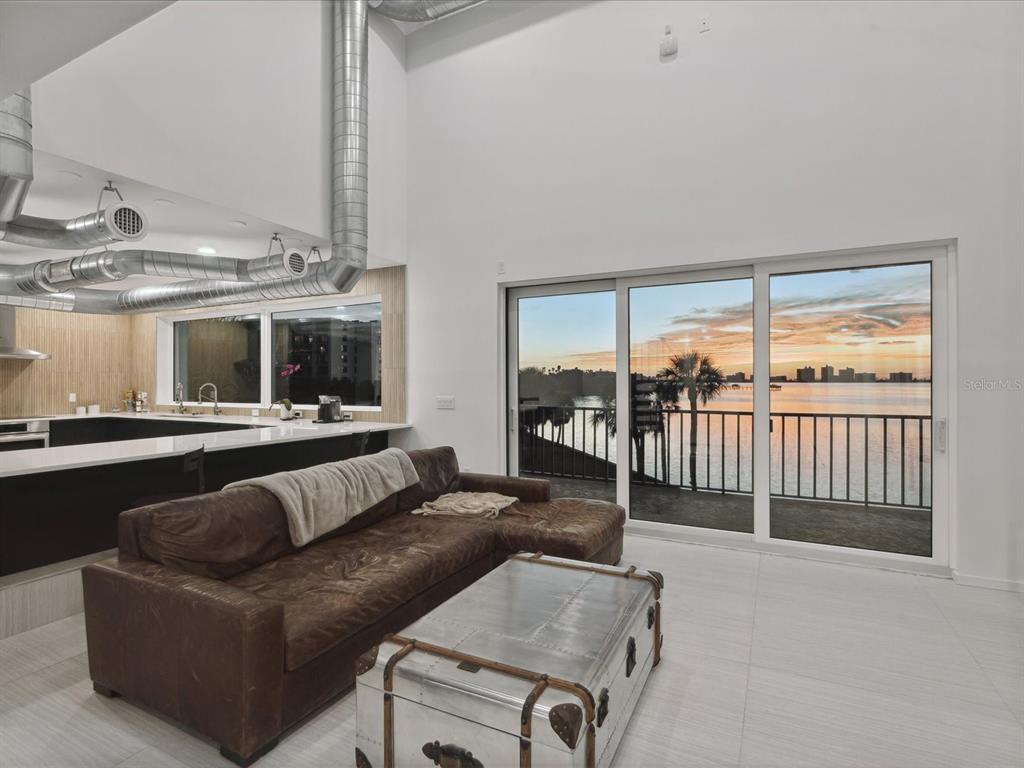 50 Coe Road, Unit 126 Belleair, FL 33756 - Photo 7 of 39 a living room with furniture and a floor to ceiling window