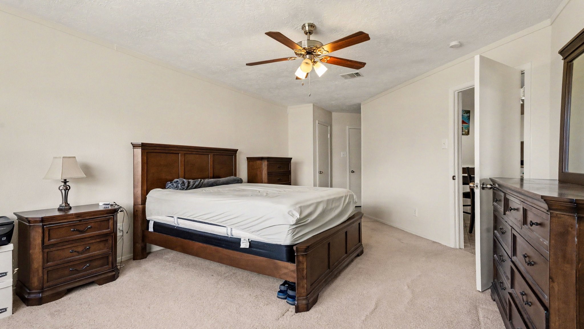 1506 Holbech Lane Channelview, TX 77530 - Photo 9 of 21 a bedroom with a bed and a chandelier