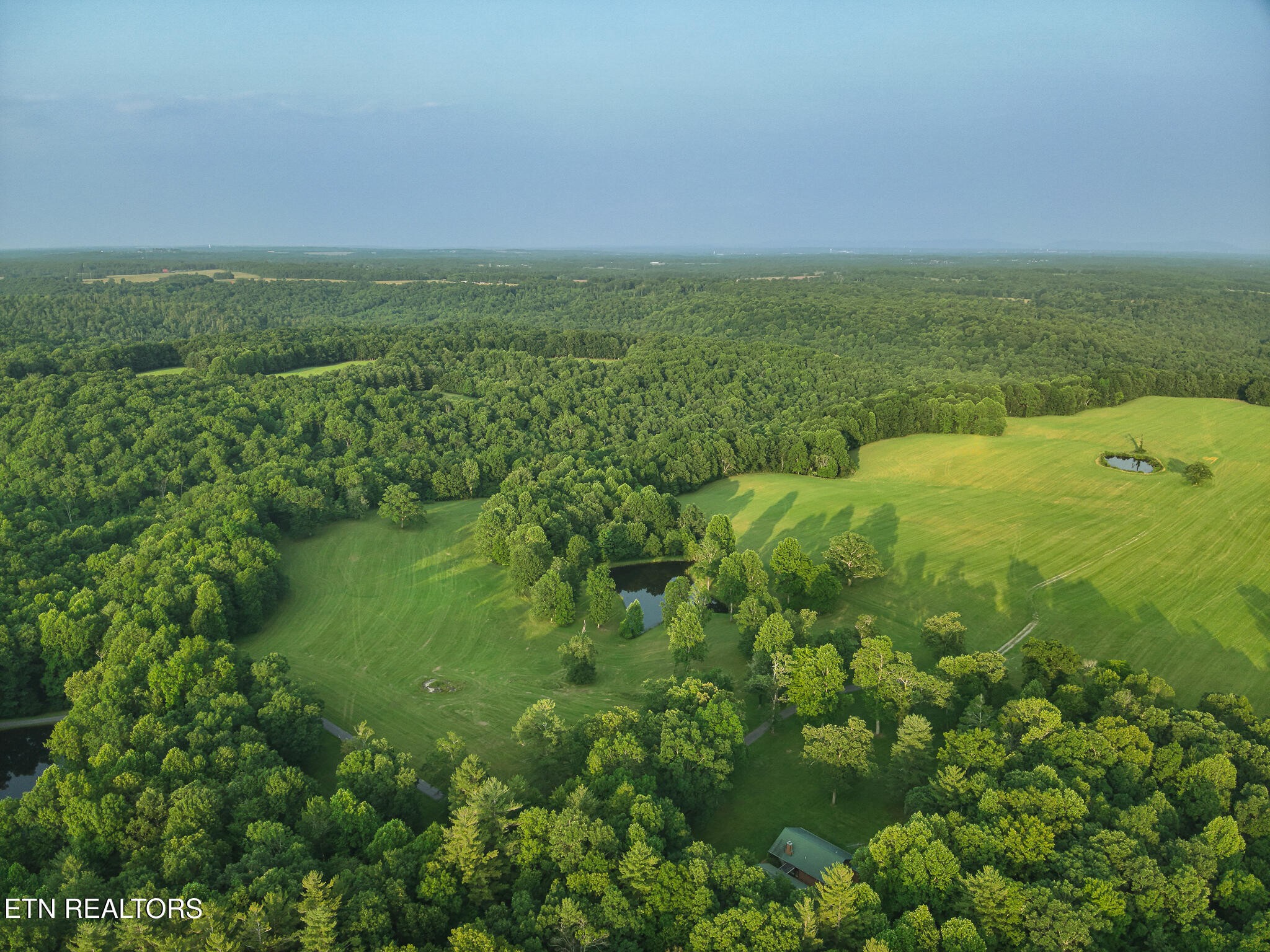 2457 Mayland Road Crossville, TN 38571 - Photo 12 of 37 an aerial view of residential houses with outdoor space and trees