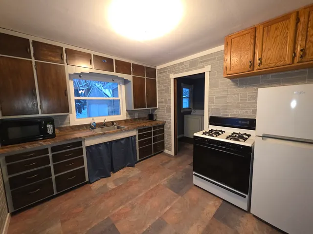a kitchen with stainless steel appliances granite countertop a stove and a refrigerator