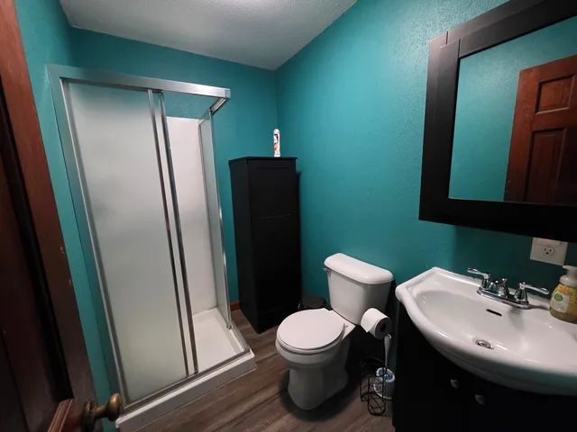 a bathroom with a toilet sink and mirror