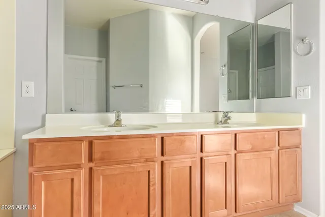 a bathroom with a double vanity sink and a mirror