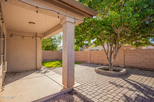 a view of a porch with wooden floor and a yard