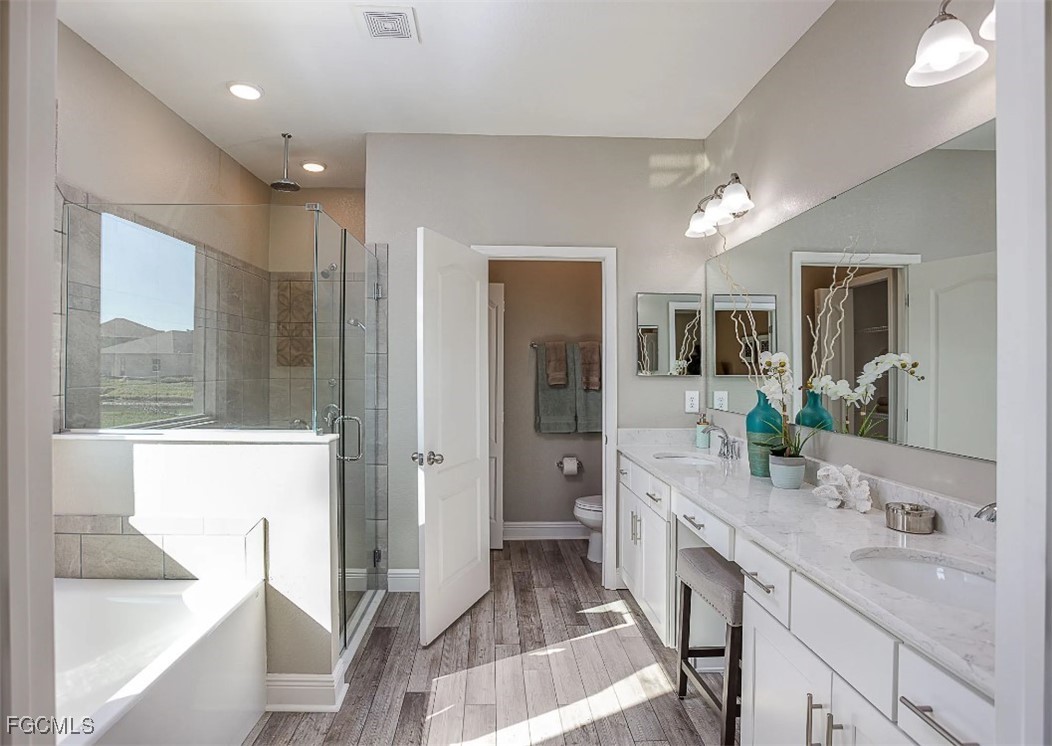 3508 14th Street Southwest Lehigh Acres, FL 33976 - Photo 11 of 23 a large bathroom with a double vanity sink a large mirror and a shower