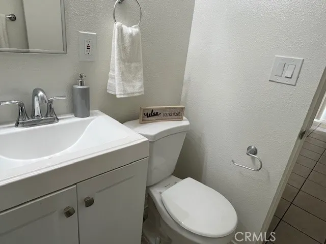 a bathroom with a sink a toilet and mirror