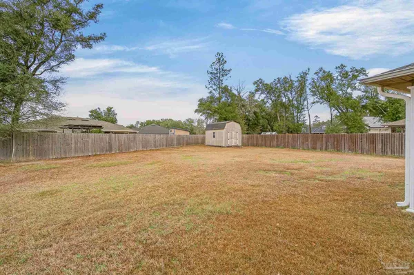 a backyard of a house with lots of green space