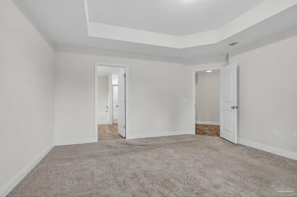 a view of an empty room and closet area