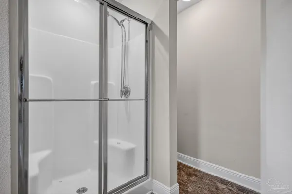 a bathroom with a glass shower door