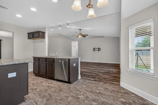 a view of kitchen with kitchen island microwave and stove top oven