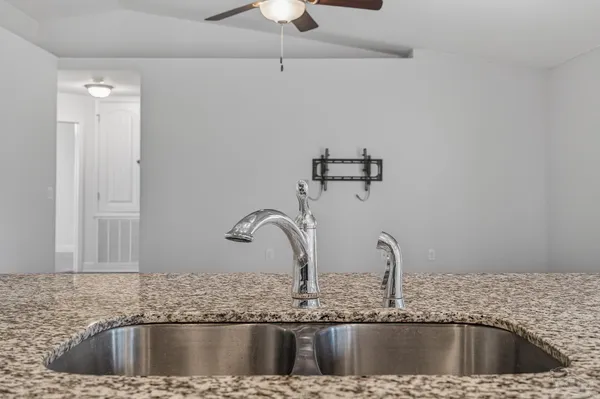 a kitchen with a sink and a granite top
