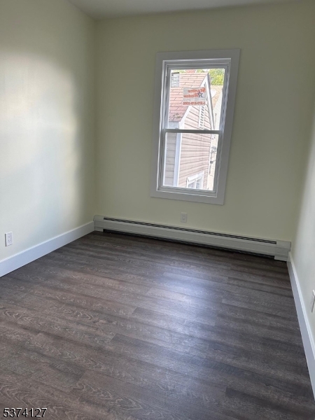 19 White Street Paterson, NJ 07522 - Photo 2 of 9 an empty room with wooden floor and windows