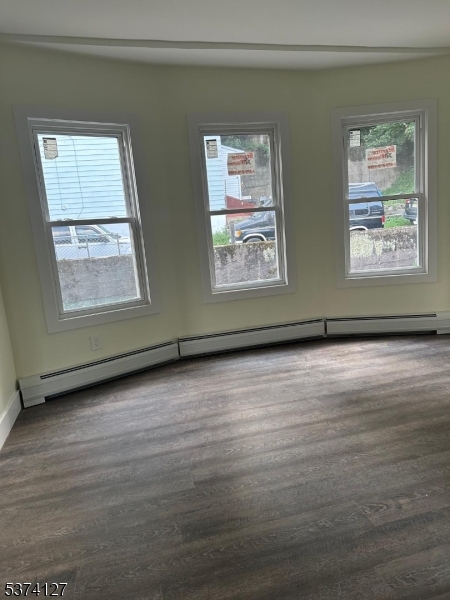 19 White Street Paterson, NJ 07522 - Photo 8 of 9 an empty room with wooden floor and windows