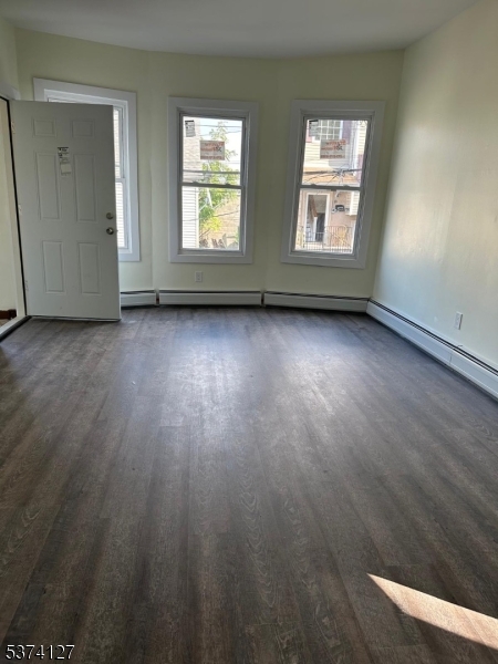 19 White Street Paterson, NJ 07522 - Photo 9 of 9 an empty room with wooden floor and windows