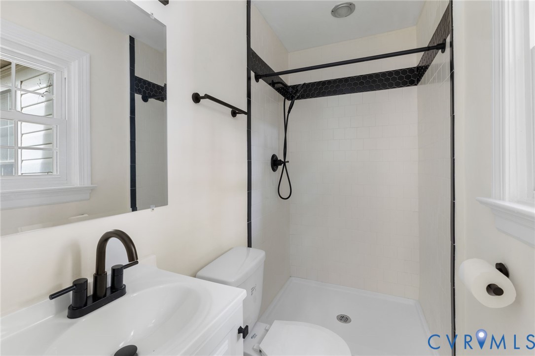 10062 Rinker Drive Mechanicsville, VA 23116 - Photo 17 of 34 a bathroom with a shower sink and mirror