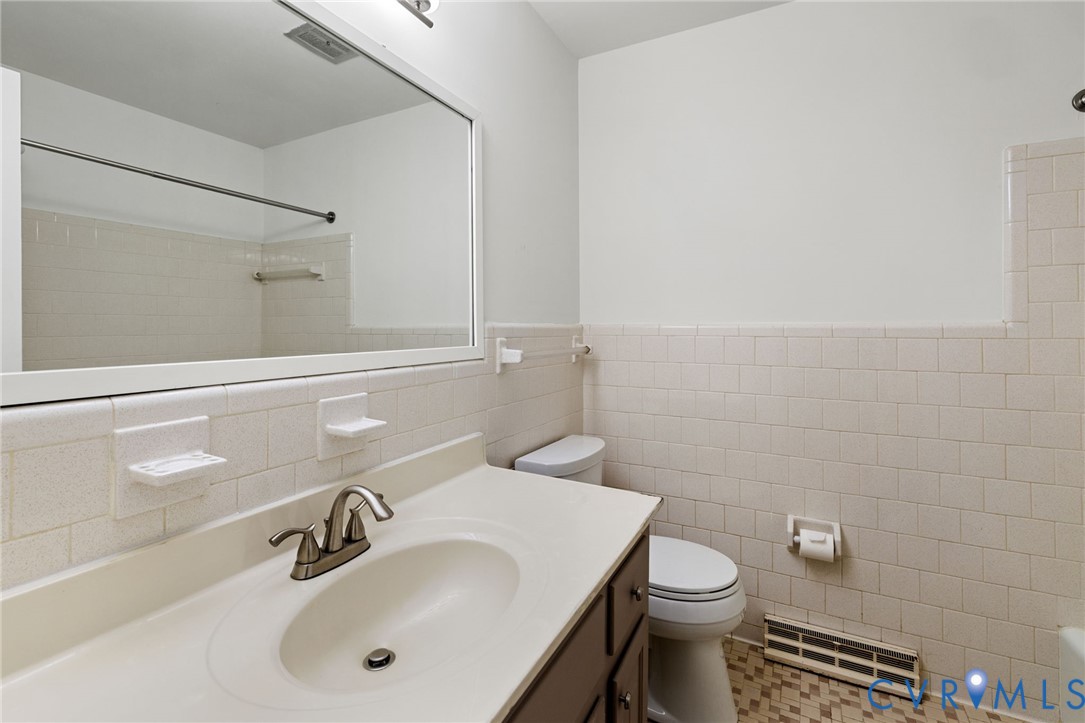 10062 Rinker Drive Mechanicsville, VA 23116 - Photo 19 of 34 a bathroom with a sink a toilet and mirror