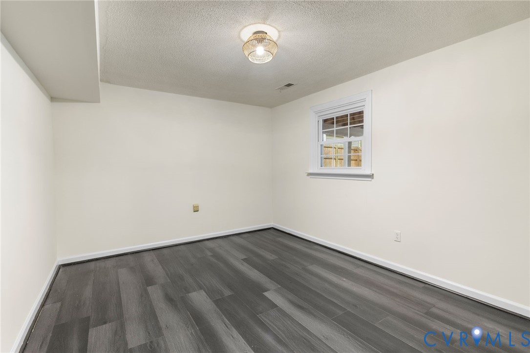 10062 Rinker Drive Mechanicsville, VA 23116 - Photo 23 of 34 an empty room with wooden floor and a window
