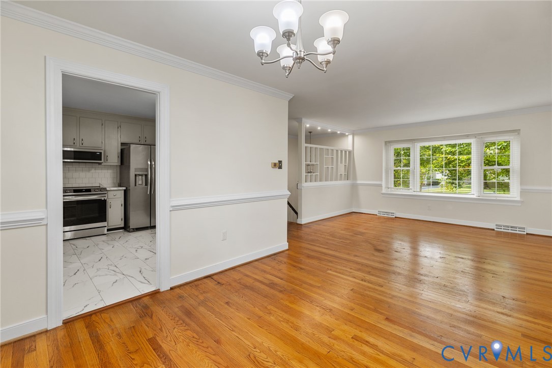 10062 Rinker Drive Mechanicsville, VA 23116 - Photo 9 of 34 wooden floor in an empty room with a window