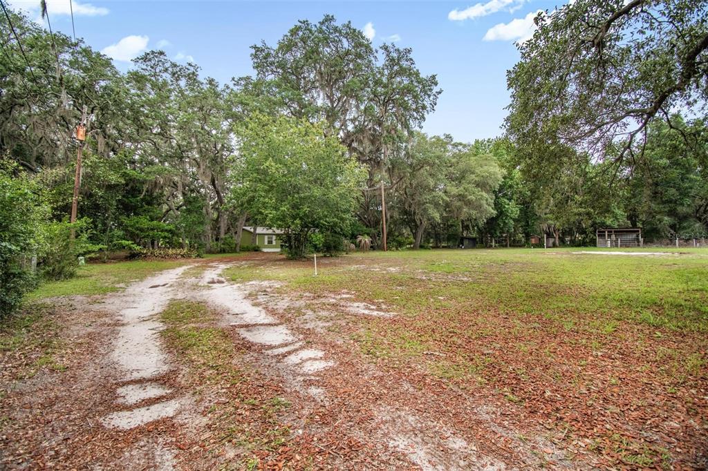 156 Kingfish Road Pomona Park, FL 32181 - Photo 9 of 55 a view of outdoor space with deck and yard