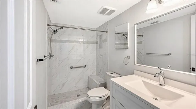 a bathroom with a sink toilet and shower