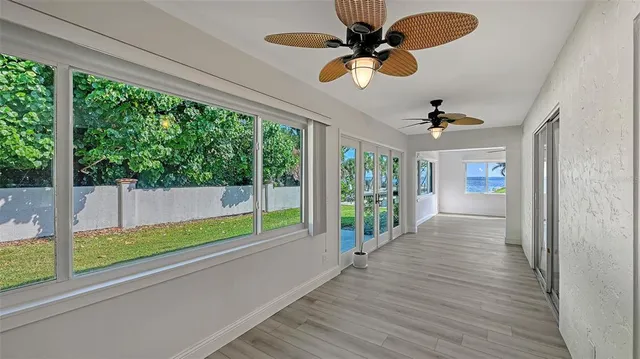 a view of a hallway with wooden floor and closet area