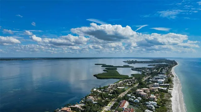 a view of a lake with a table and chairs