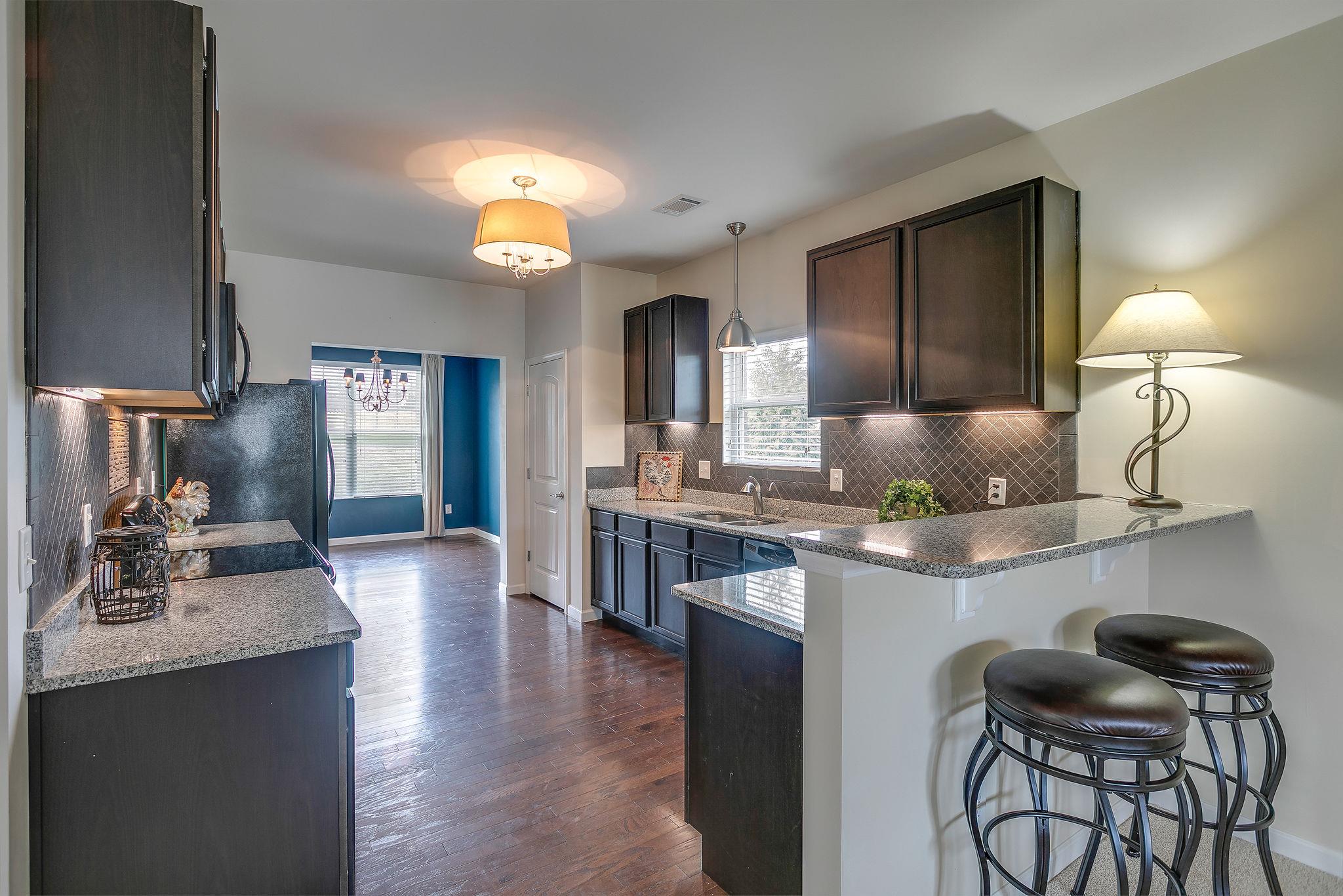 4020 Pendleton Drive Spring Hill, TN 37174 - Photo 11 of 28 Kitchen features Granite Counter-Tops, Custom Backsplash made from Slate and Tile, Nearly New Side-by-Side Refrigerator Stays with the Home.