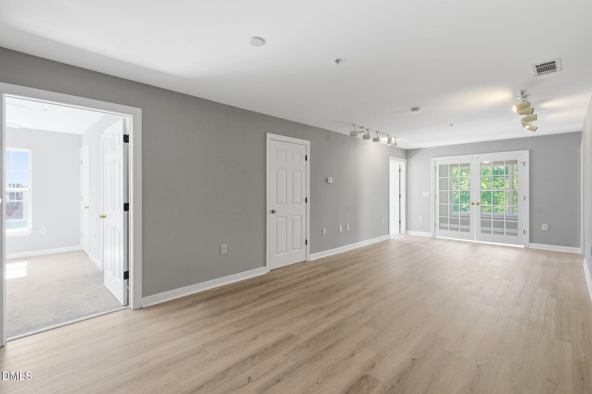 929 Morreene Road, Unit A23 Durham, NC 27705 - Photo 6 of 41 a view of an empty room with wooden floor and a window