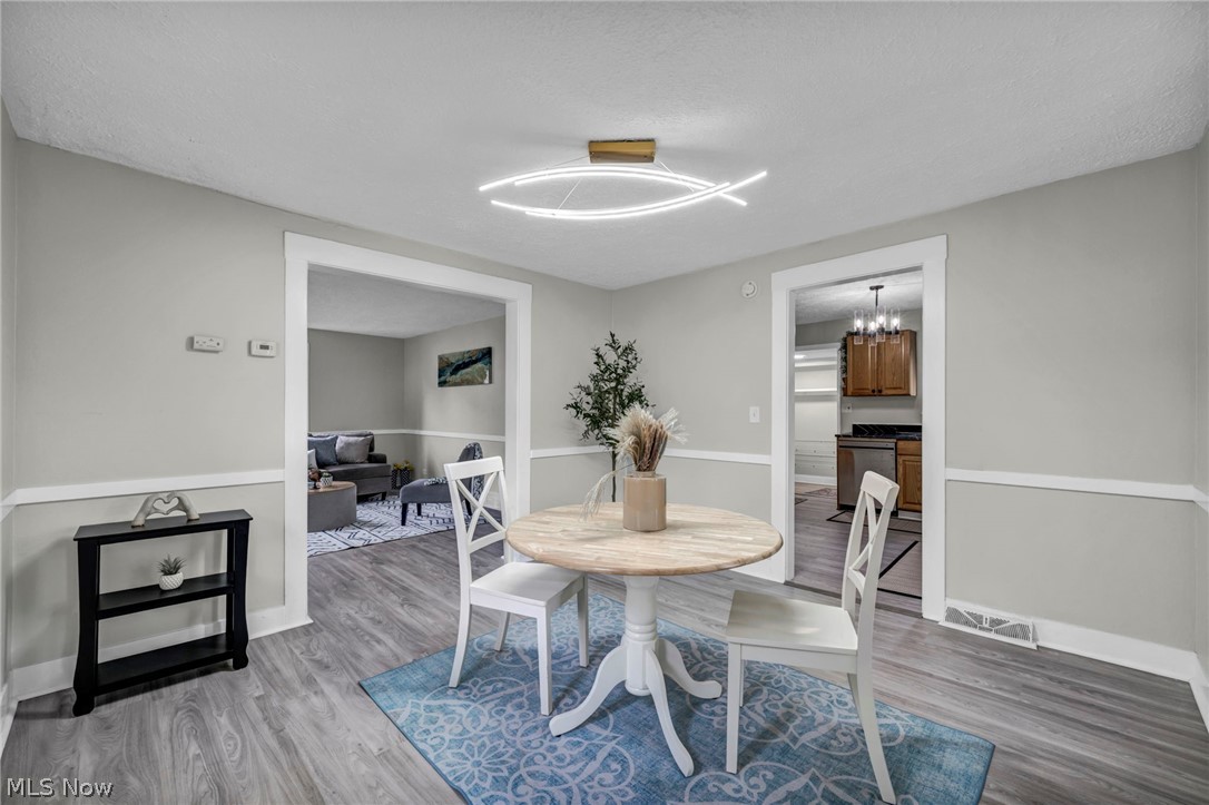 1603 Winchester Road Lyndhurst, OH 44124 - Photo 12 of 34 Bright and inviting dining space featuring new flooring and updated lighting that creates the perfect setting for everyday meals or hosting guests.