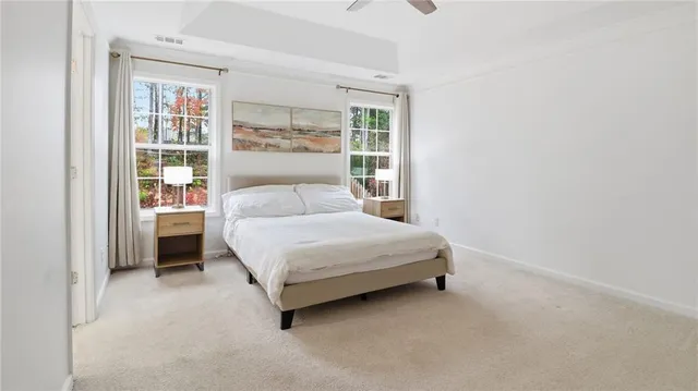 a bedroom with a bed lamp and a window