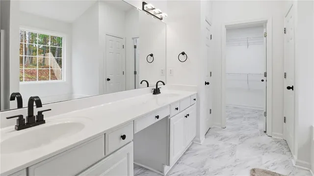 a spacious bathroom with double sink and a mirror
