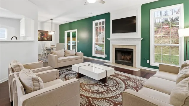 a living room with furniture a flat screen tv and a fireplace