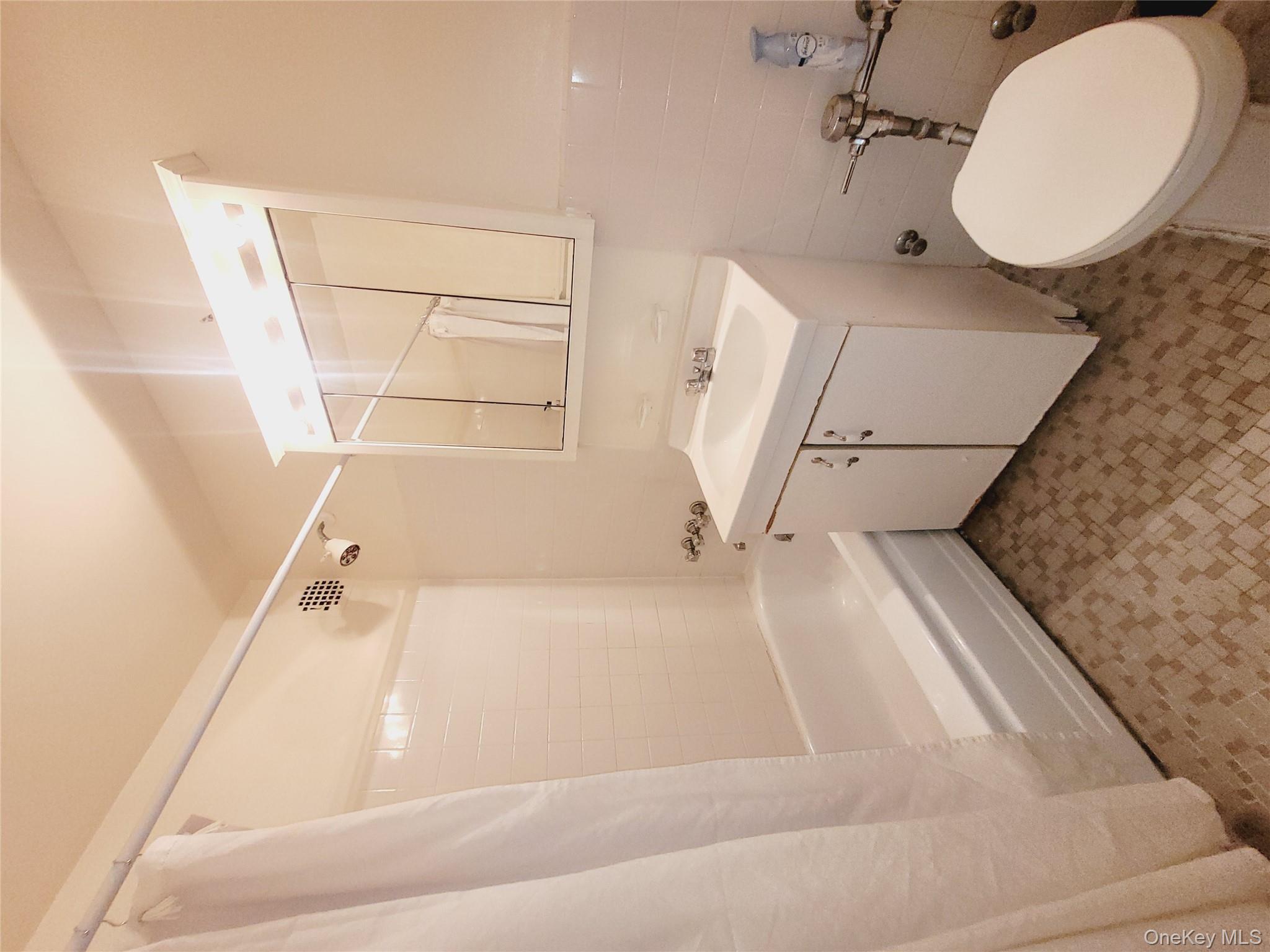 99-30 59th Avenue, Unit 3K Queens, NY 11368 - Photo 11 of 21 a bathroom with a sink a toilet and shower