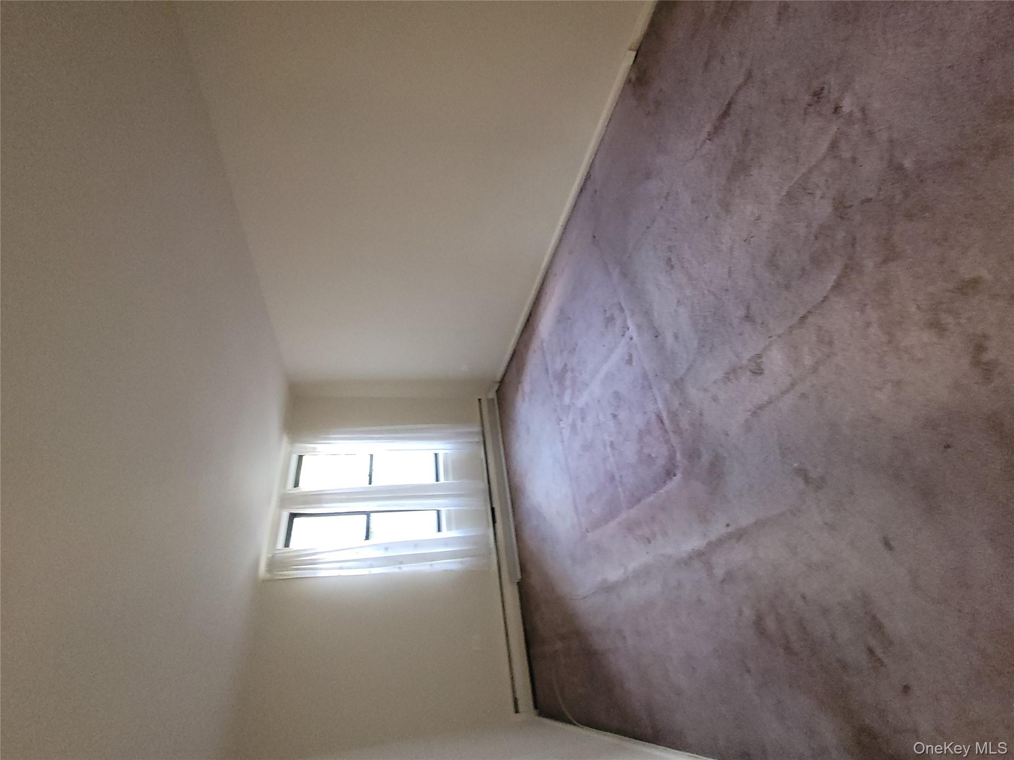 99-30 59th Avenue, Unit 3K Queens, NY 11368 - Photo 12 of 21 an empty room with a window