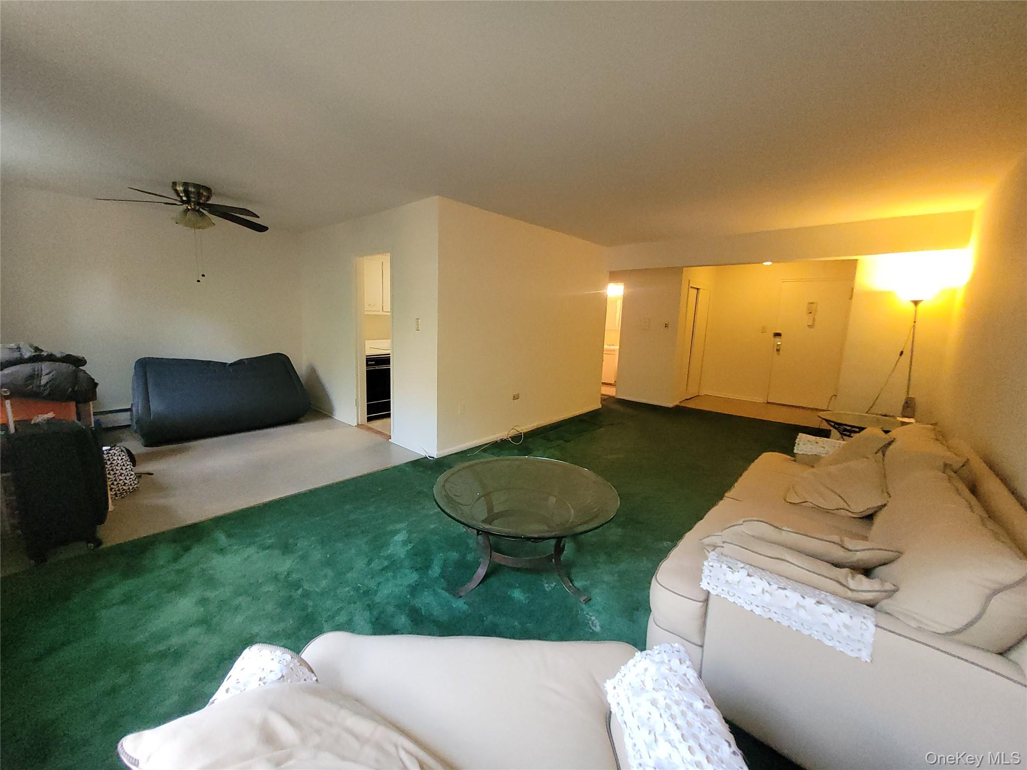 99-30 59th Avenue, Unit 3K Queens, NY 11368 - Photo 6 of 21 a bedroom with a bed and a chair