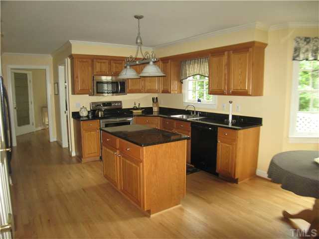 14405 Possum Track Road Raleigh, NC 27614 - Photo 24 of 25 There's great working counterspace in the kitchen. The hardwood floors stretch on into the mudroom off the garage (covered door visible at left of picture) Kitchen