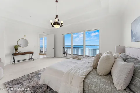 a bedroom with a bed a window and couch