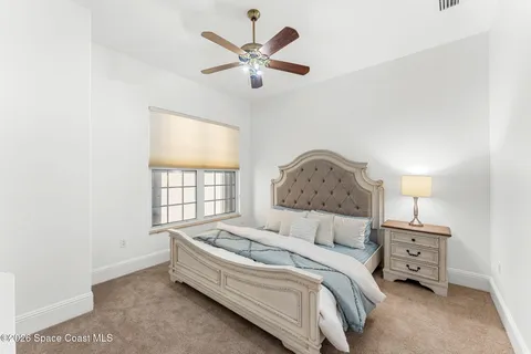 a spacious bedroom with a bed and a window