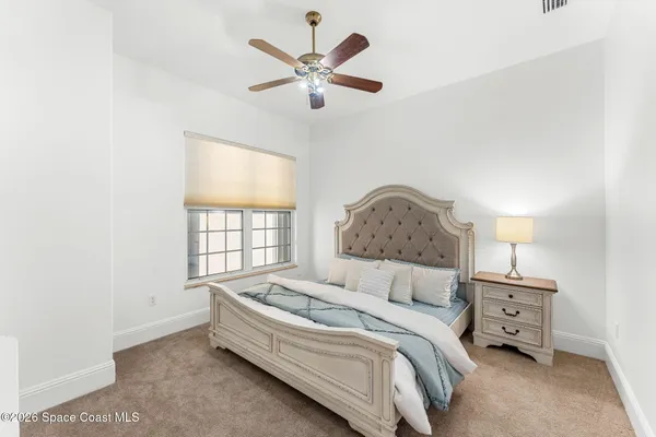 a spacious bedroom with a bed and a window