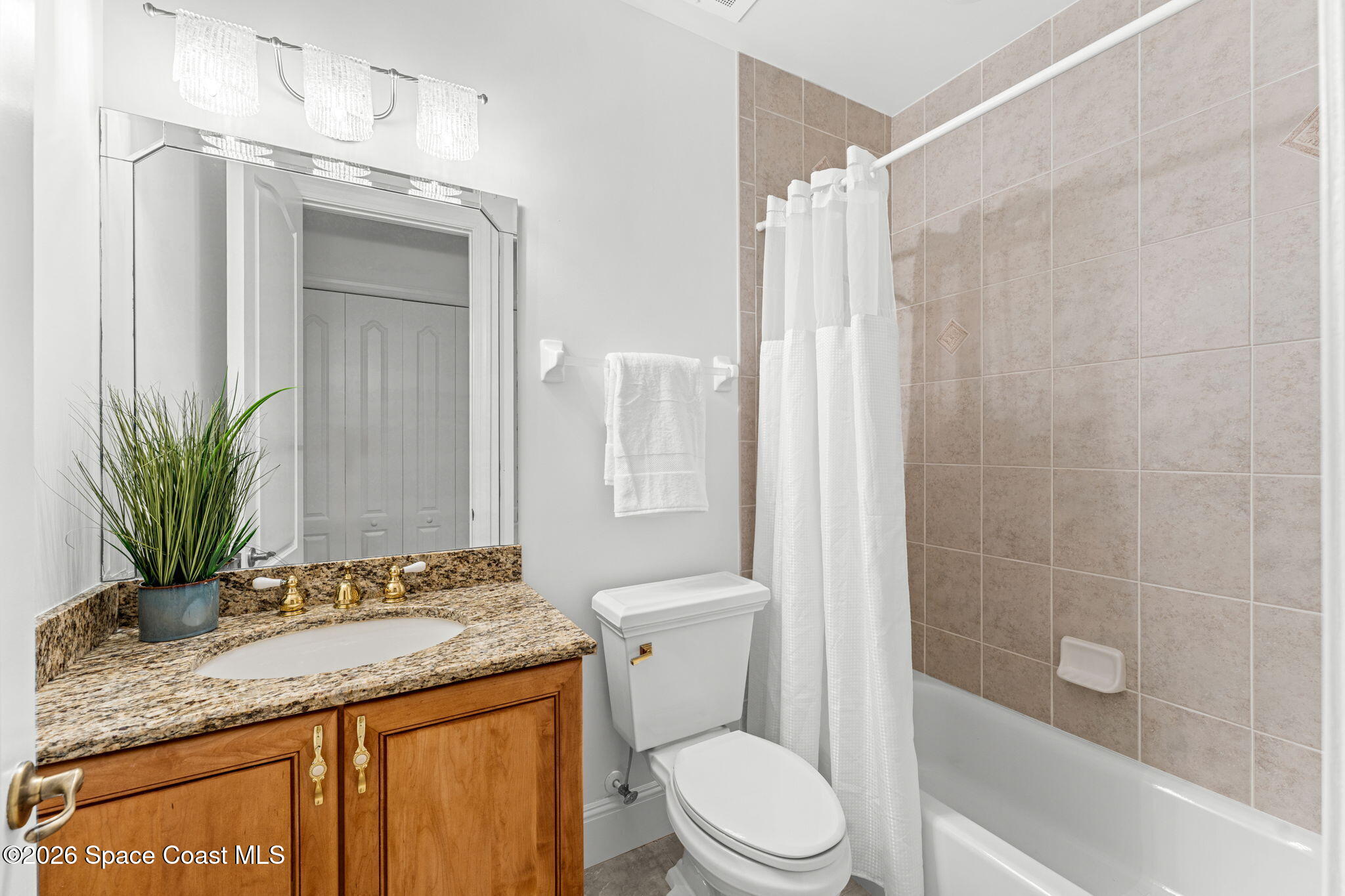 4955 Dixie Highway Northeast, Unit 802 Palm Bay, FL 32905 - Photo 20 of 30 a bathroom with a granite countertop sink a toilet and shower