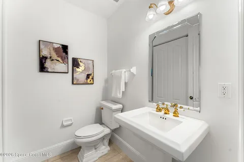 a white toilet sitting next to a bathroom sink