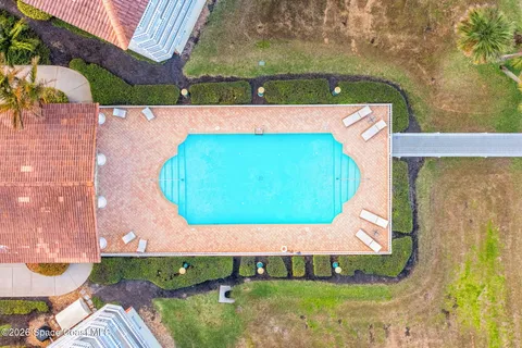 a view of a swimming pool with a garden and seating space