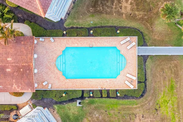 a view of a swimming pool with a garden and seating space