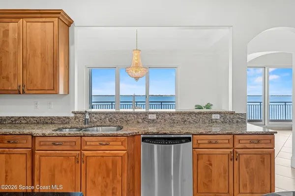 a kitchen with granite countertop a sink and a wooden cabinets