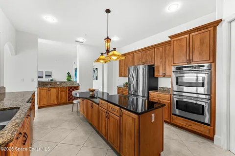 a kitchen with stainless steel appliances a sink stove and refrigerator